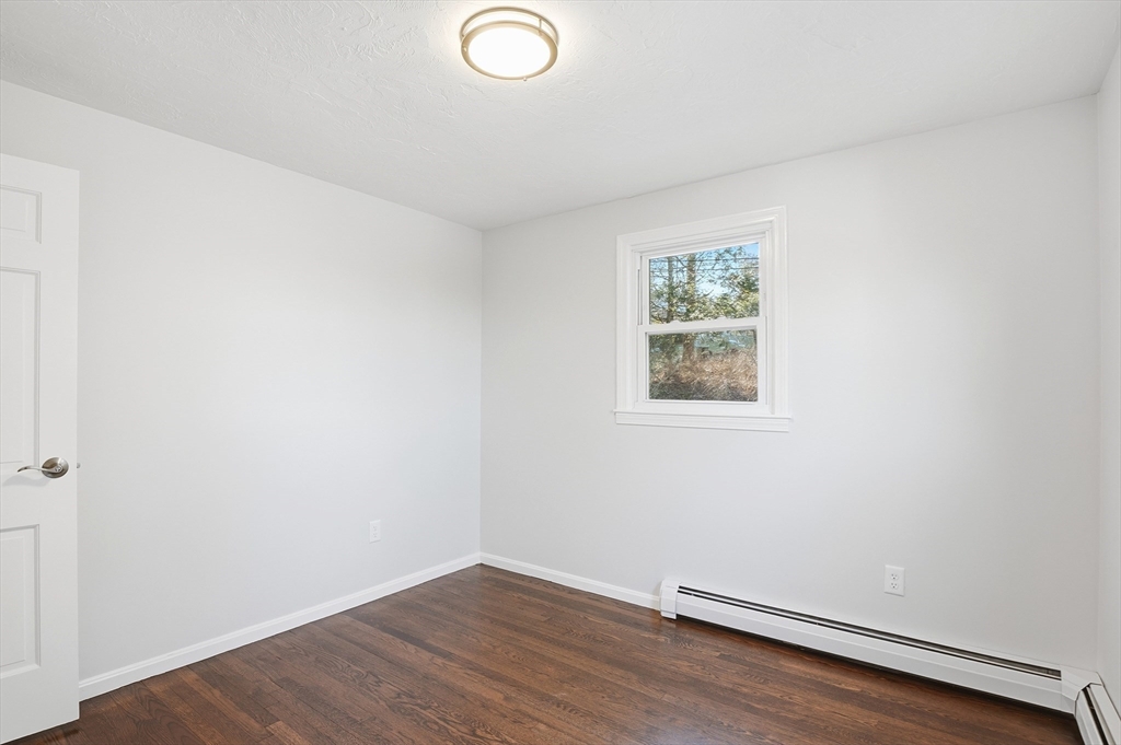 2 Laurel Lane Spencer, MA 01562 - Photo 22 of 42 an empty room with wooden floor and windows