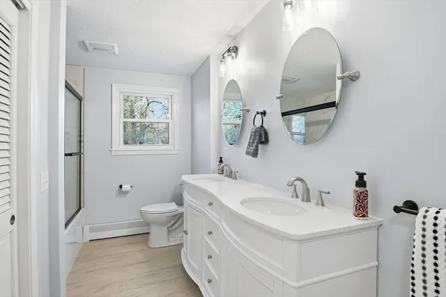 a bathroom with a toilet sink and mirror