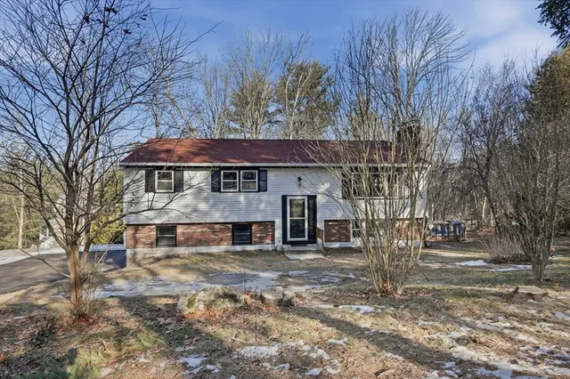 a view of a house with a yard covered with snow in the yard