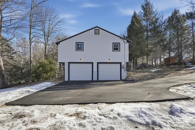 a view of a house with a yard covered in snow
