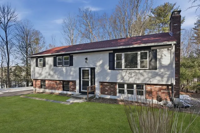 a view of house with a yard