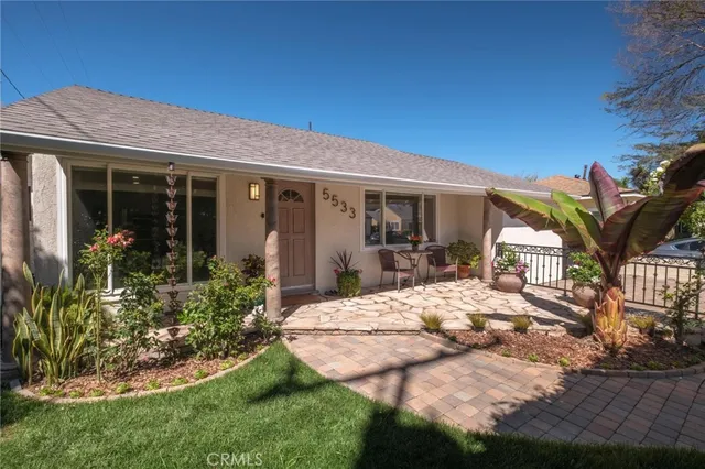 a view of a house with backyard porch and sitting area