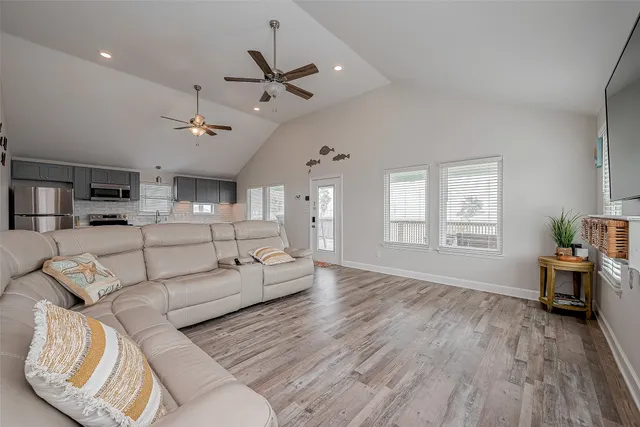 a living room with furniture and wooden floor