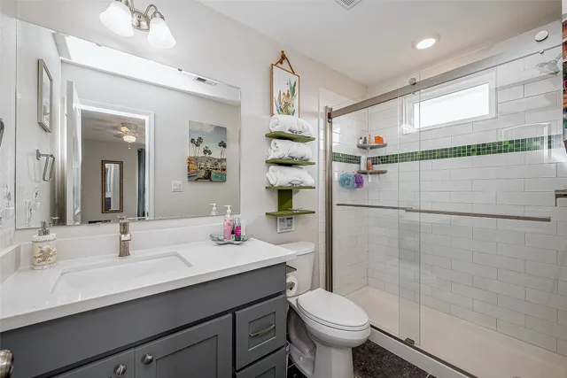 a bathroom with a sink toilet and shower