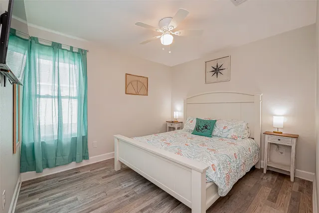 a bedroom with a large bed and a chandelier