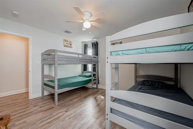 a bedroom with bunk bed and a desk