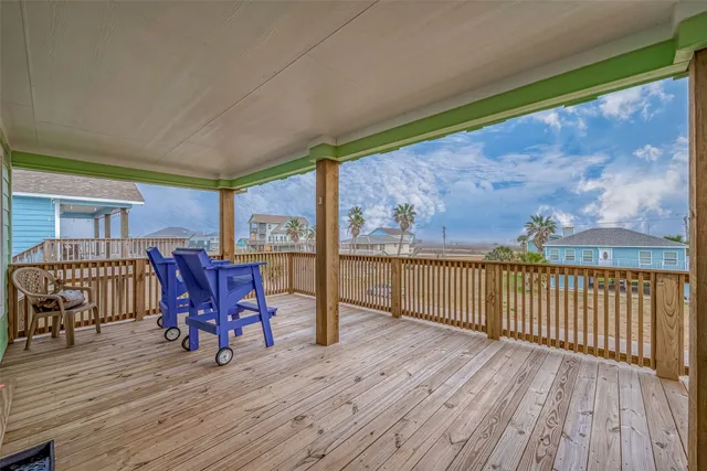 a view of a chairs and table in patio with wooden floor