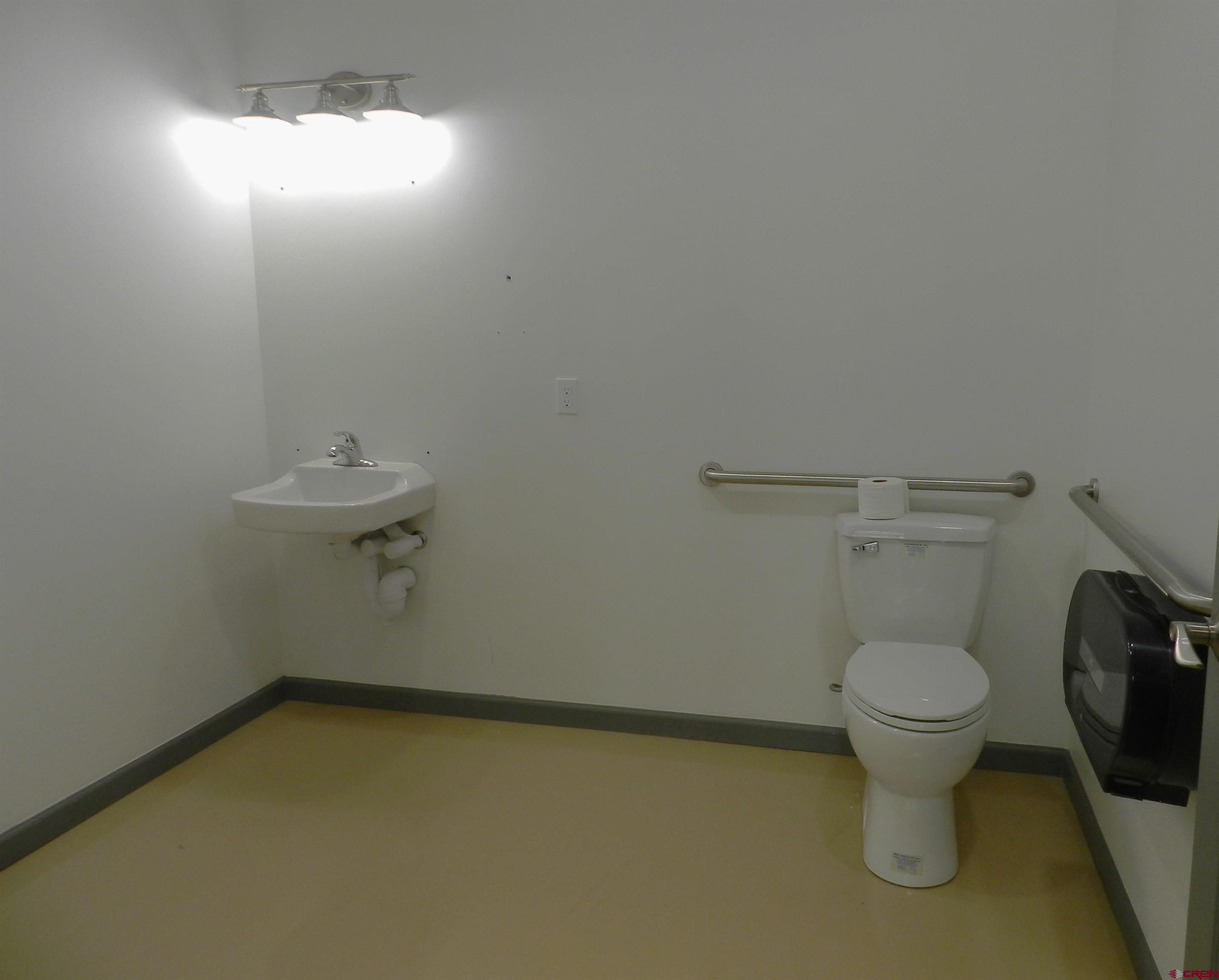 202 East Main Street Montrose, CO 81401 - Photo 13 of 29 a bathroom with a toilet and a sink