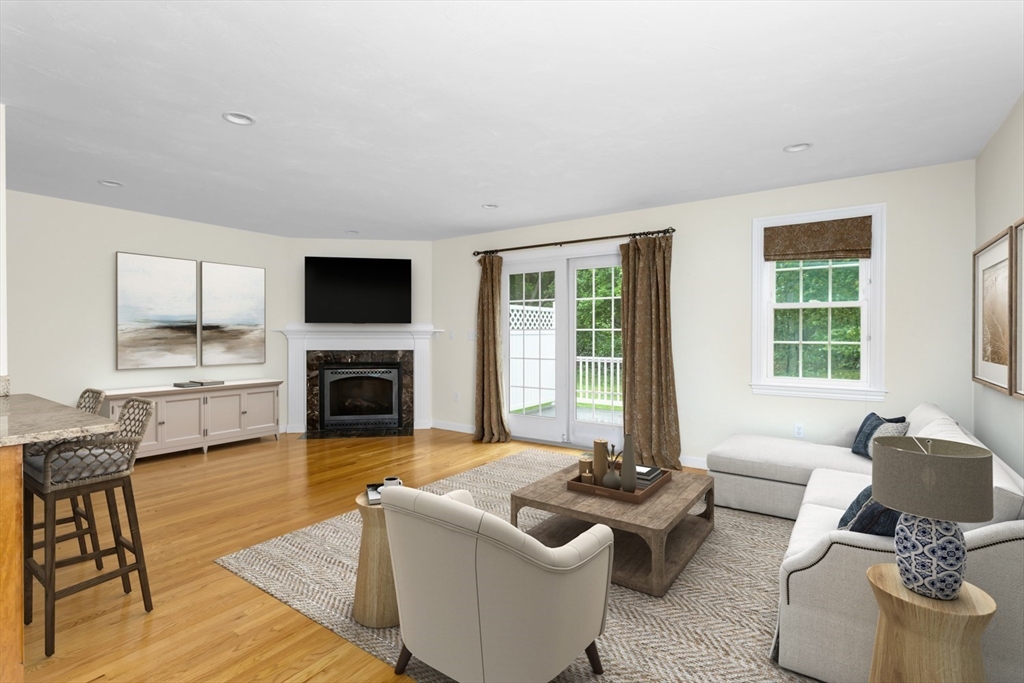 49 Beaver Street, Unit 49 Franklin, MA 02038 - Photo 3 of 46 a living room with furniture window and a fireplace