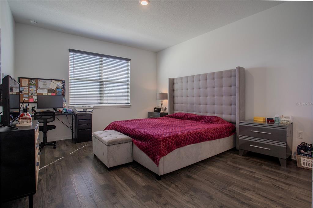 4724 Cragmere Loop Clermont, FL 34711 - Photo 11 of 37 a bedroom with a bed and a window