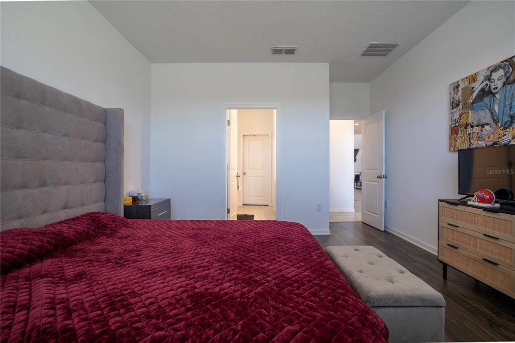 4724 Cragmere Loop Clermont, FL 34711 - Photo 12 of 37 a bedroom with a bed and a flat screen tv