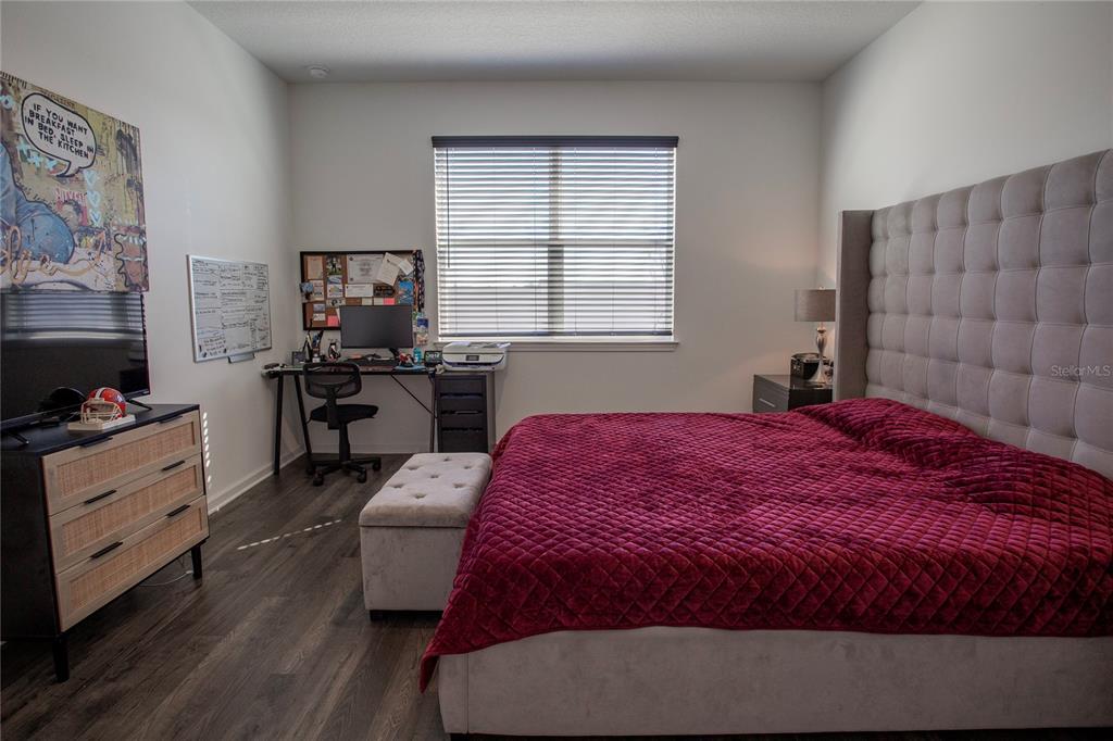 4724 Cragmere Loop Clermont, FL 34711 - Photo 13 of 37 a bedroom with a bed and a window