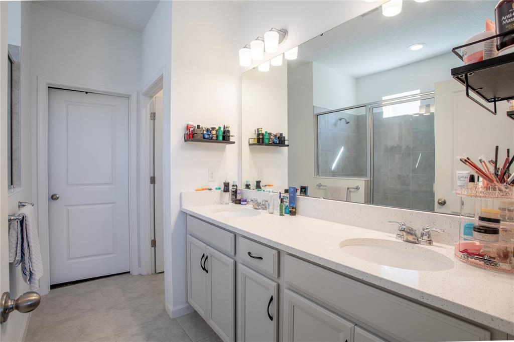 4724 Cragmere Loop Clermont, FL 34711 - Photo 14 of 37 a bathroom with a sink double vanity and a mirror