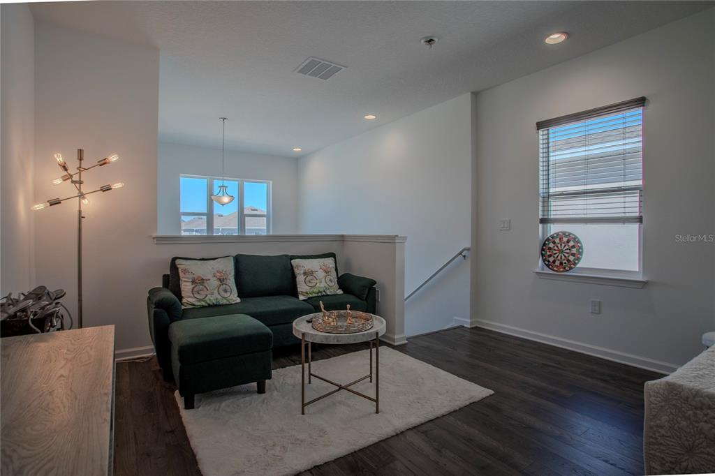 4724 Cragmere Loop Clermont, FL 34711 - Photo 20 of 37 a living room with furniture and wooden floor