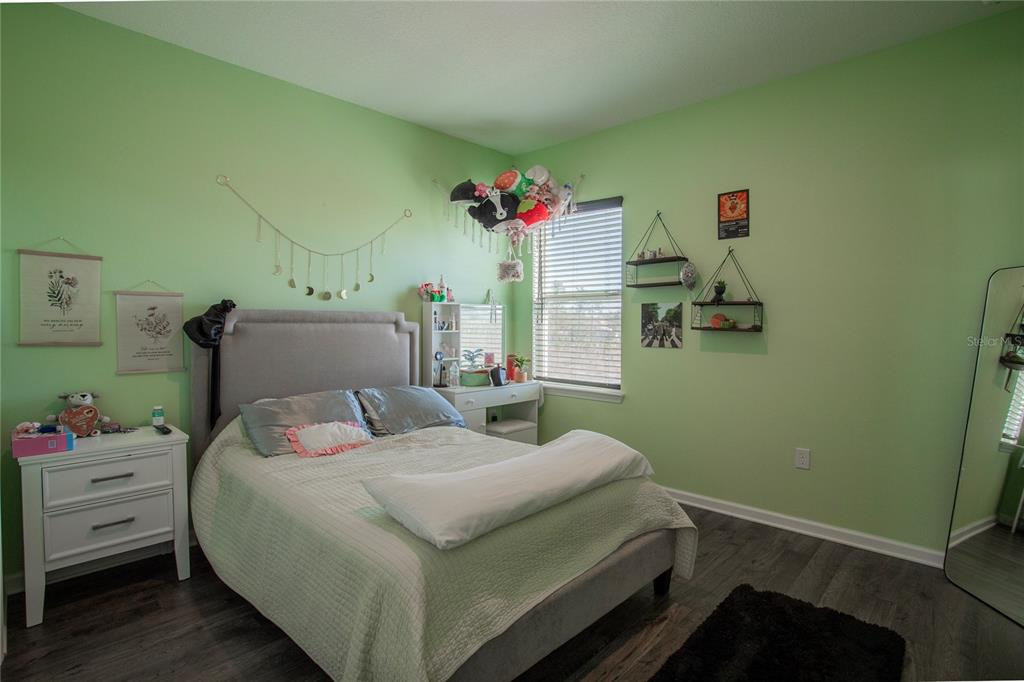 4724 Cragmere Loop Clermont, FL 34711 - Photo 21 of 37 a bedroom with a bed and a dresser