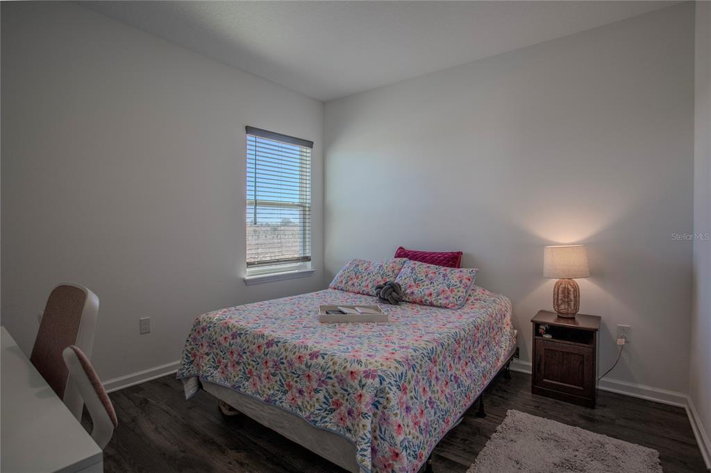 4724 Cragmere Loop Clermont, FL 34711 - Photo 23 of 37 a bedroom with a bed a desk and chair