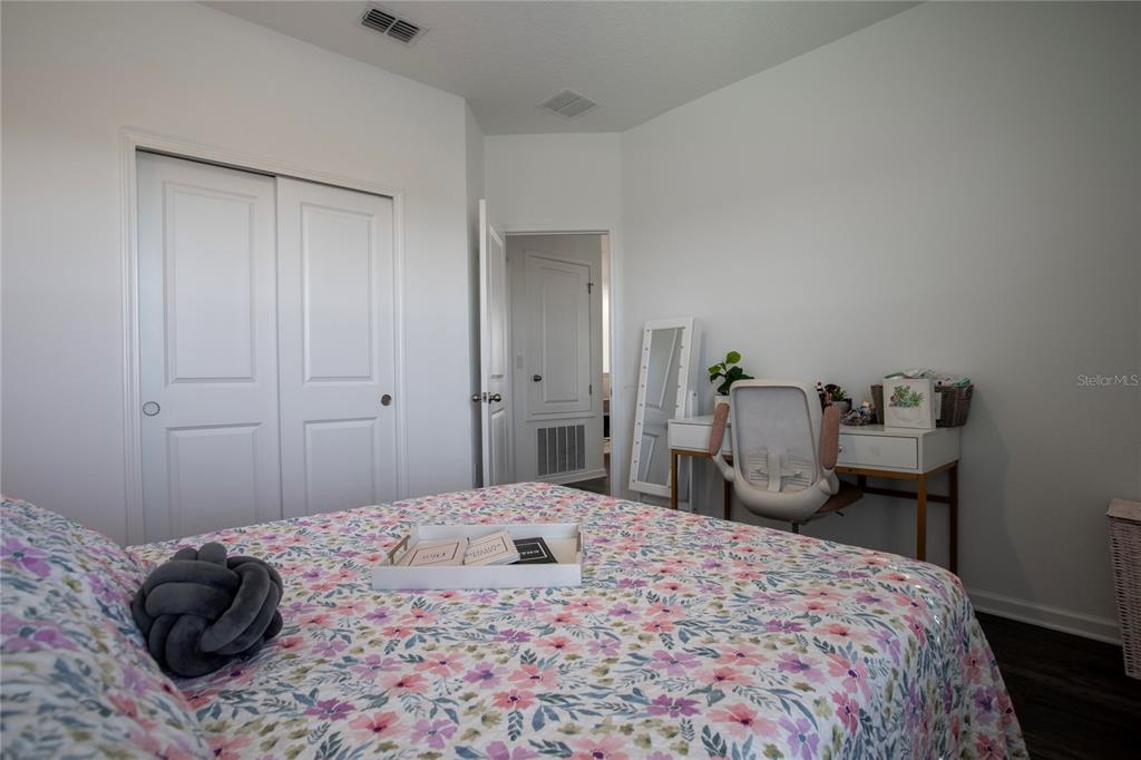 4724 Cragmere Loop Clermont, FL 34711 - Photo 24 of 37 a bedroom with a bed and a dresser