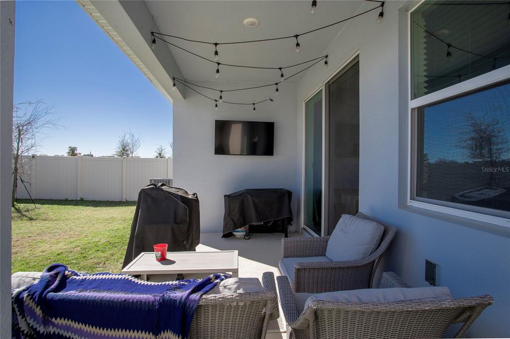4724 Cragmere Loop Clermont, FL 34711 - Photo 28 of 37 a living room with furniture a flat screen tv and a fireplace
