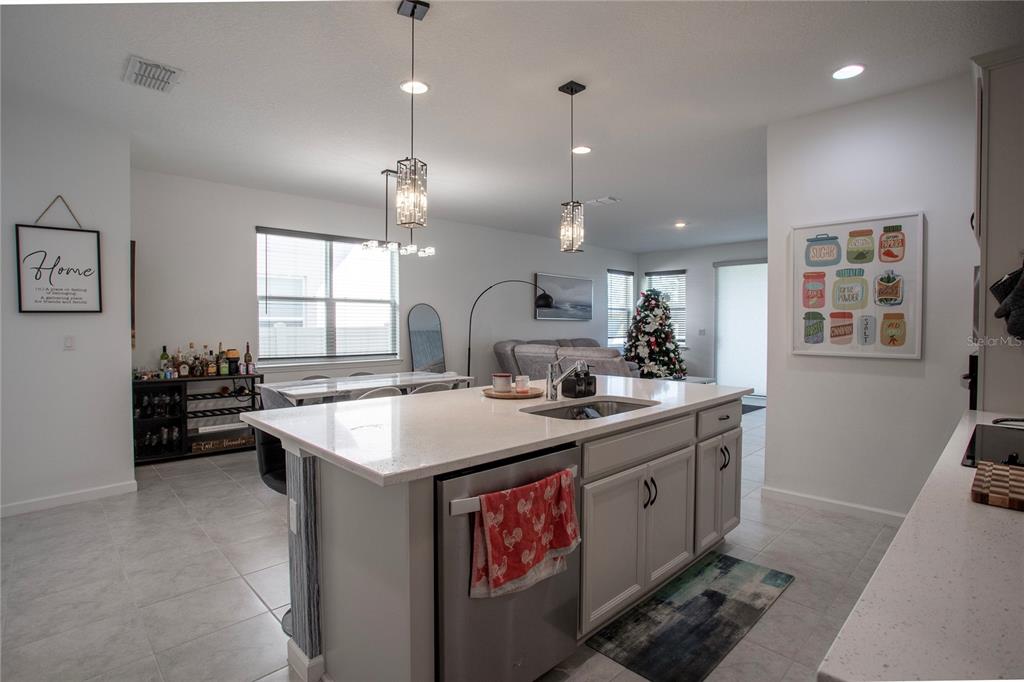 4724 Cragmere Loop Clermont, FL 34711 - Photo 8 of 37 a kitchen with a stove a sink a counter space and a window