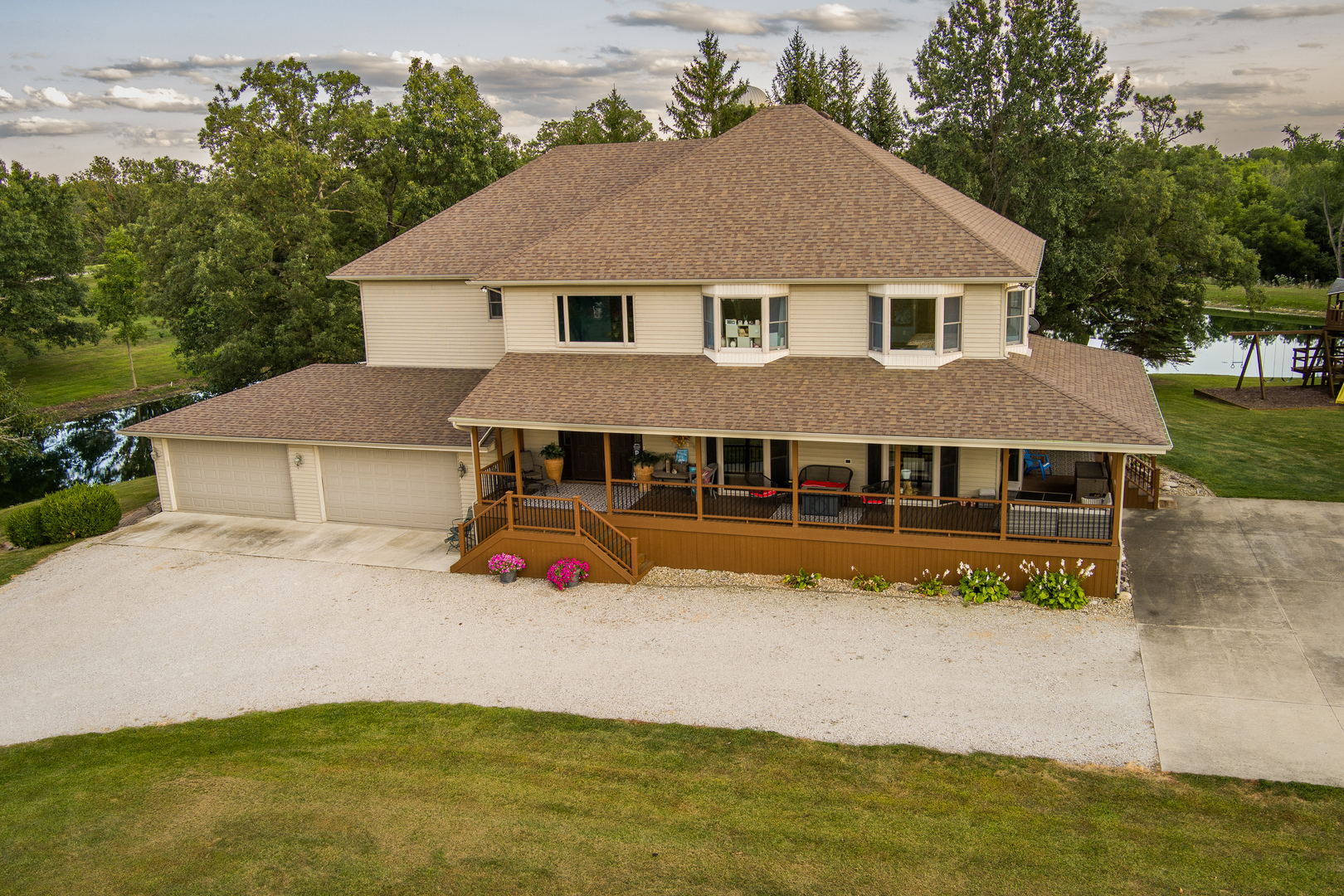 a view of house with garden space and sitting area