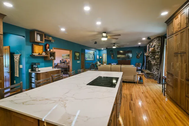 a kitchen with stainless steel appliances a sink a table and chairs