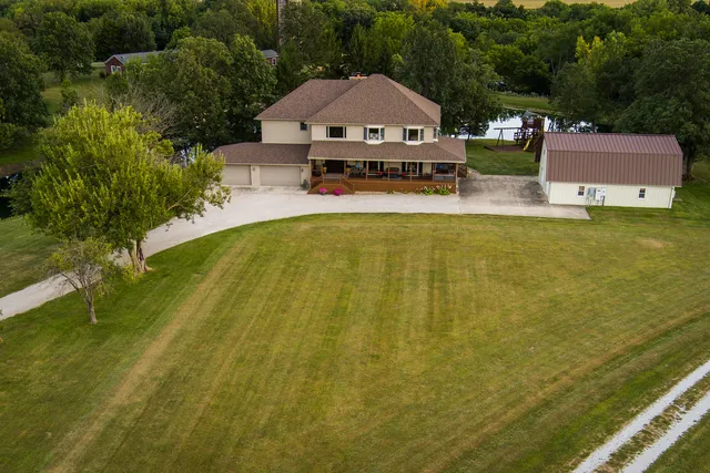 a aerial view of a house with swimming pool next to a yard