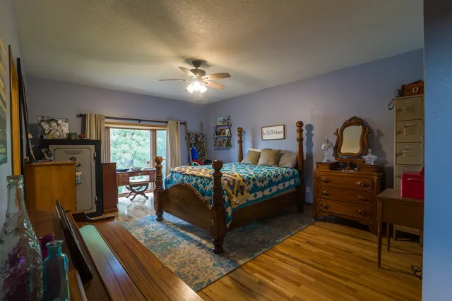 a bedroom with furniture and a wooden floor