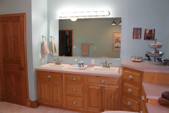 a kitchen with kitchen island granite countertop a stove and a sink