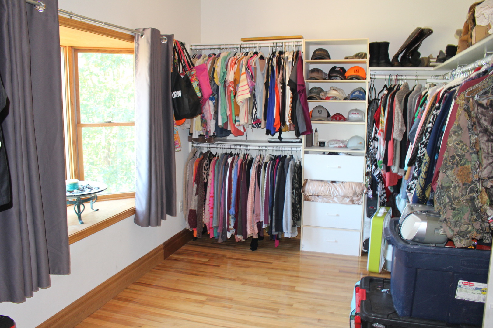 4789 Leghorn Road Clinton, IL 61727 - Photo 39 of 84 a view of a walk in closet with clothes and shoes