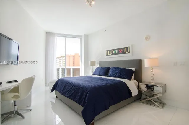 a bedroom with a bed a table and chair