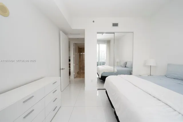 a room with a bed and a large mirror