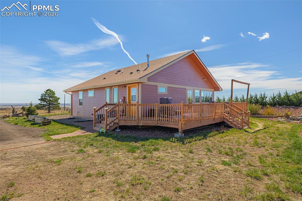 8480 Delaware Road Colorado Springs, CO 80926 - Photo 28 of 49 Back of property with a wooden deck and a yard