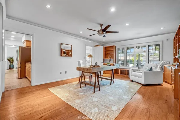 a living room with furniture and a view of kitchen