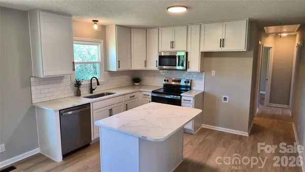 a view of a room with wooden floor and staircase