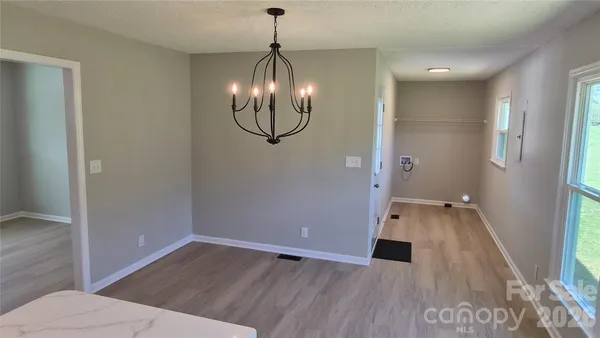 an empty room with a fan and a fan