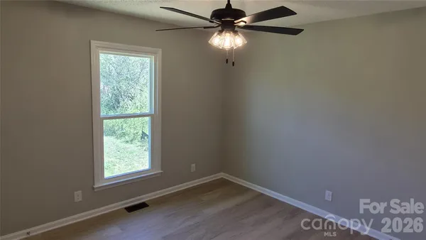 a bathroom with a granite countertop bathtub shower sink vanity and toilet