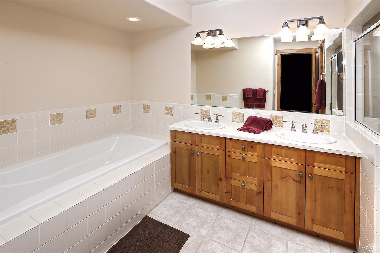 161 Fall Creek Road Edwards, CO 81632 - Photo 12 of 16 a bathroom with a tub sink and mirror