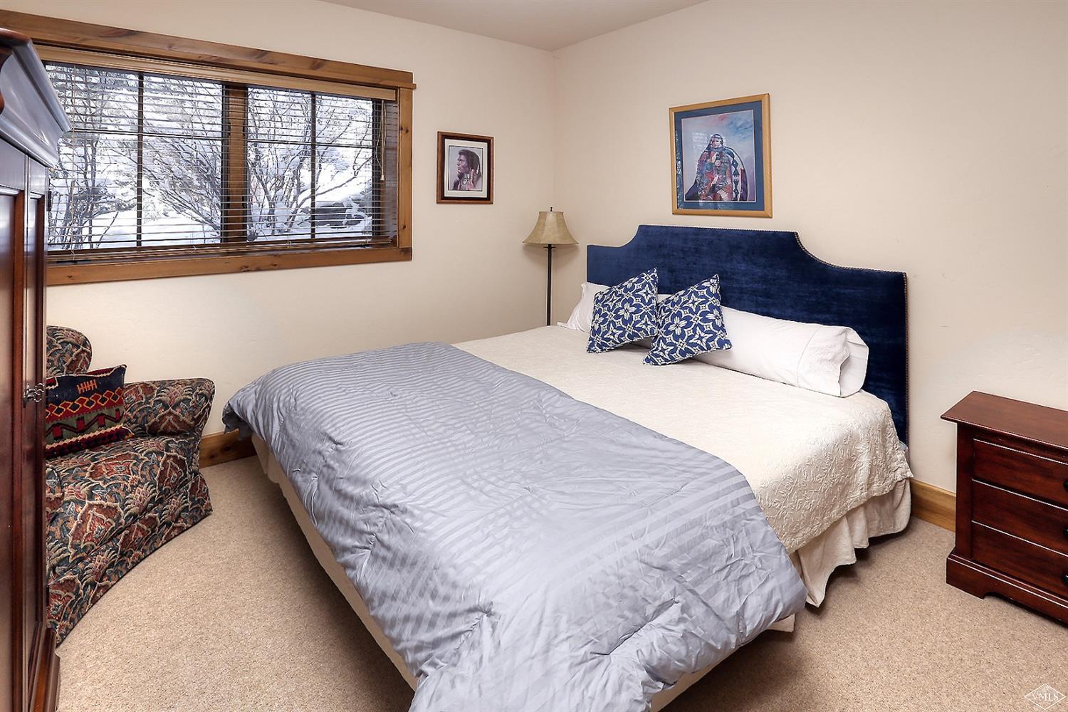 161 Fall Creek Road Edwards, CO 81632 - Photo 13 of 16 a bedroom with bed and wooden floor