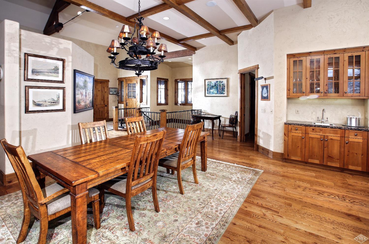 161 Fall Creek Road Edwards, CO 81632 - Photo 2 of 16 a view of a dining room with furniture a chandelier and wooden floor