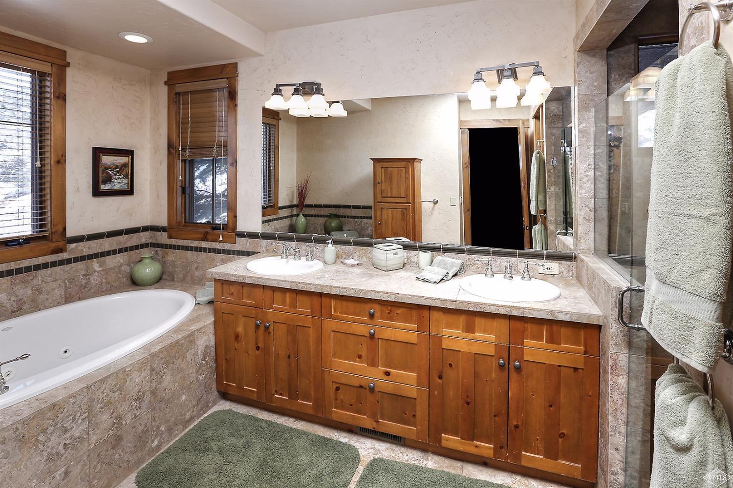 161 Fall Creek Road Edwards, CO 81632 - Photo 6 of 16 a bathroom with a tub sink and mirror