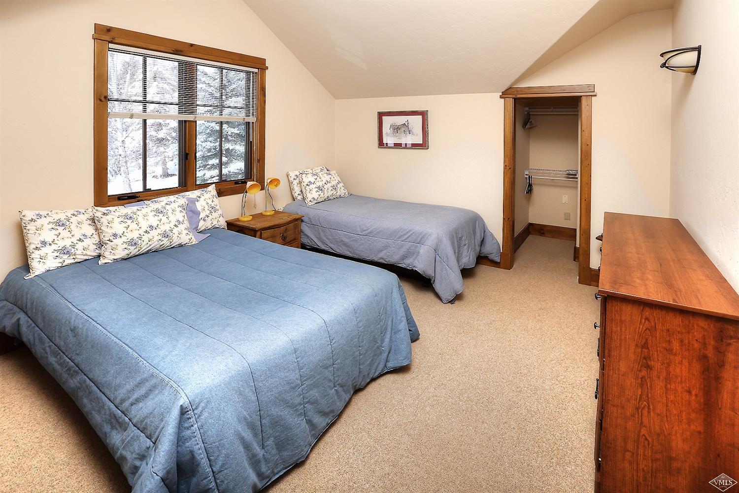 161 Fall Creek Road Edwards, CO 81632 - Photo 8 of 16 a bedroom with two beds and a window