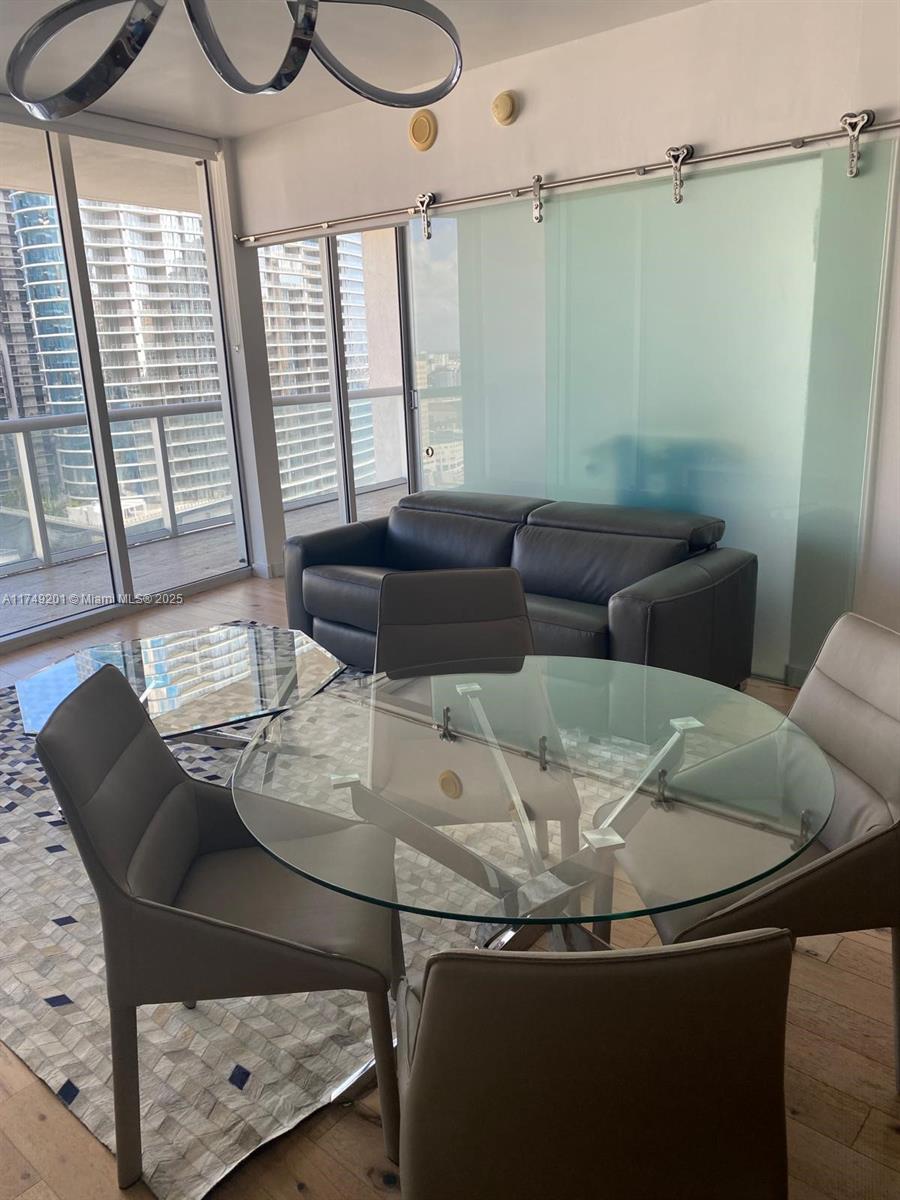485 Brickell Avenue, Unit 2603 Miami, FL 33131 - Photo 7 of 16 a dining room with furniture and a window