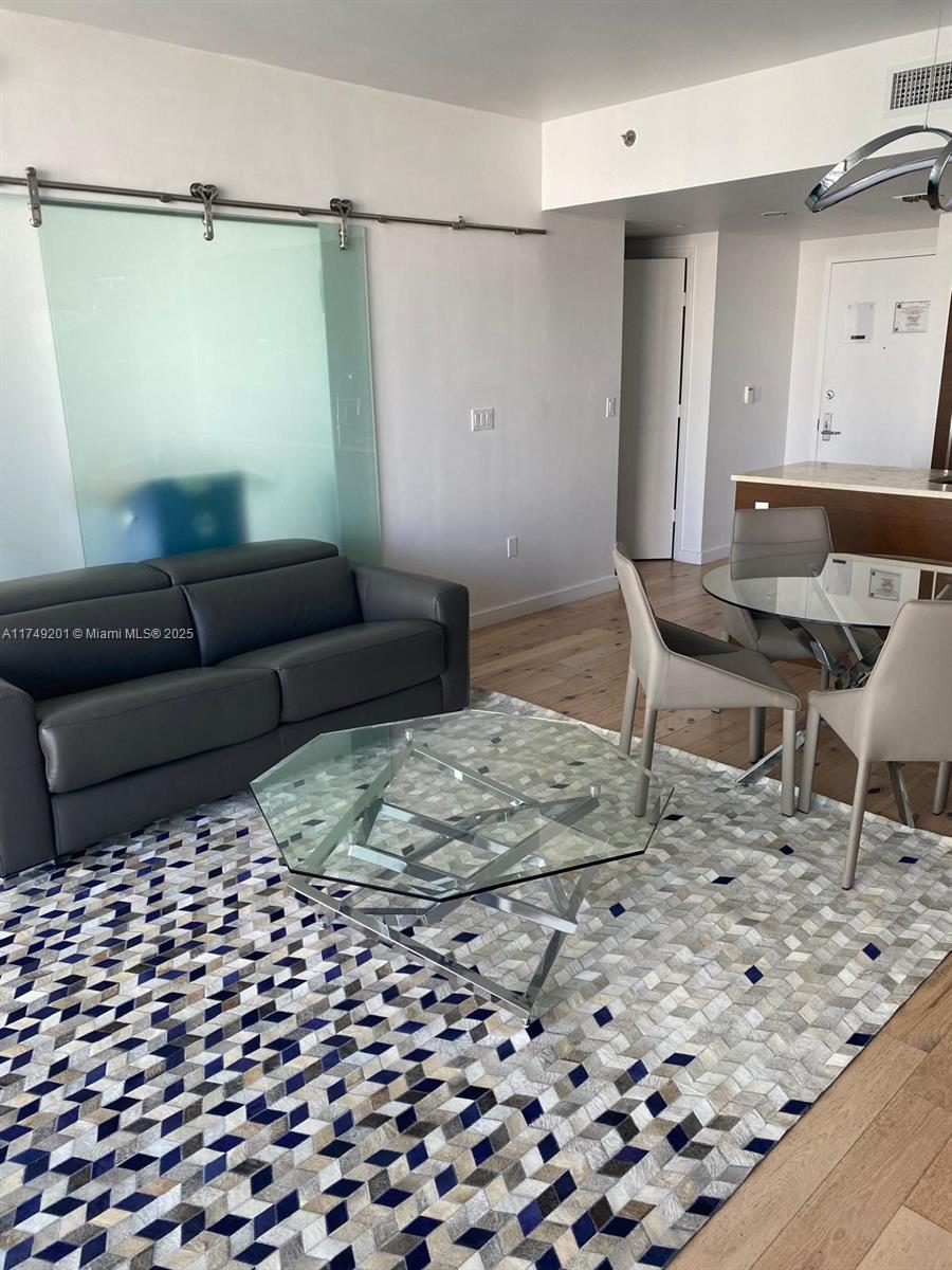 485 Brickell Avenue, Unit 2603 Miami, FL 33131 - Photo 8 of 16 a living room with a couch and a rug
