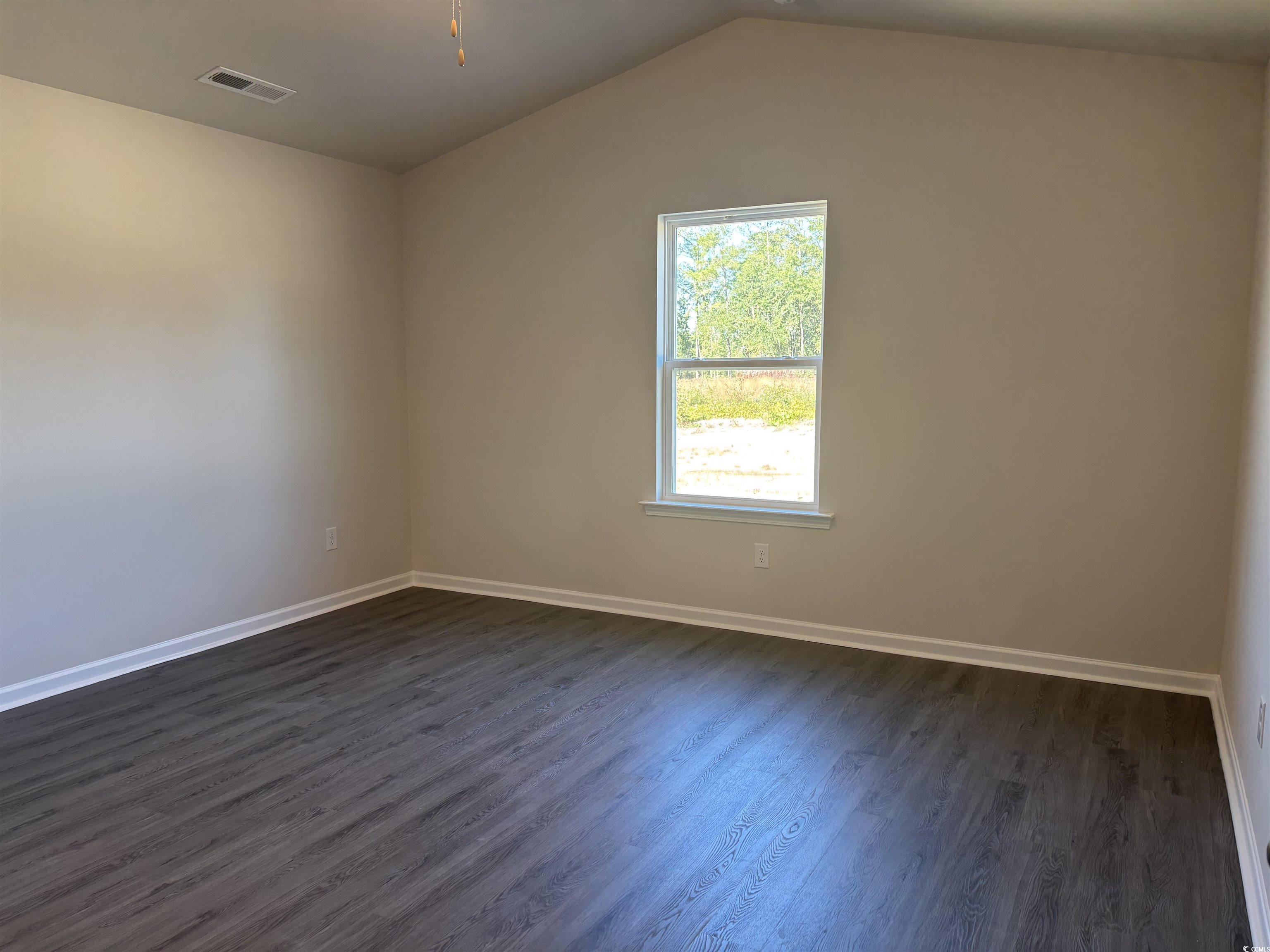 1110 Oscar Road Little River, SC 29566 - Photo 5 of 6 Unfurnished room with dark wood-style flooring and lofted ceiling