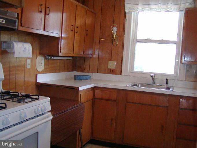 920 Calwell Road Baltimore, MD 21229 - Photo 5 of 5 a kitchen with a sink and cabinets