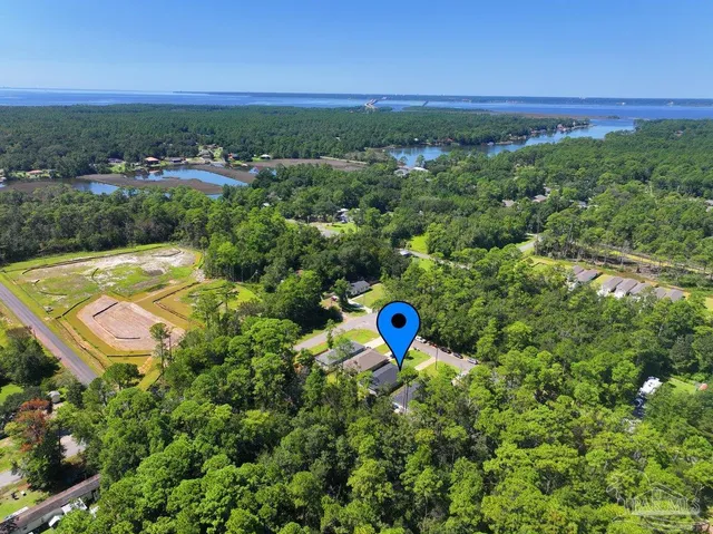 an aerial view of a house with a swimming pool
