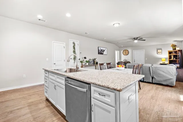 a view of living room with granite countertop furniture and wooden floor