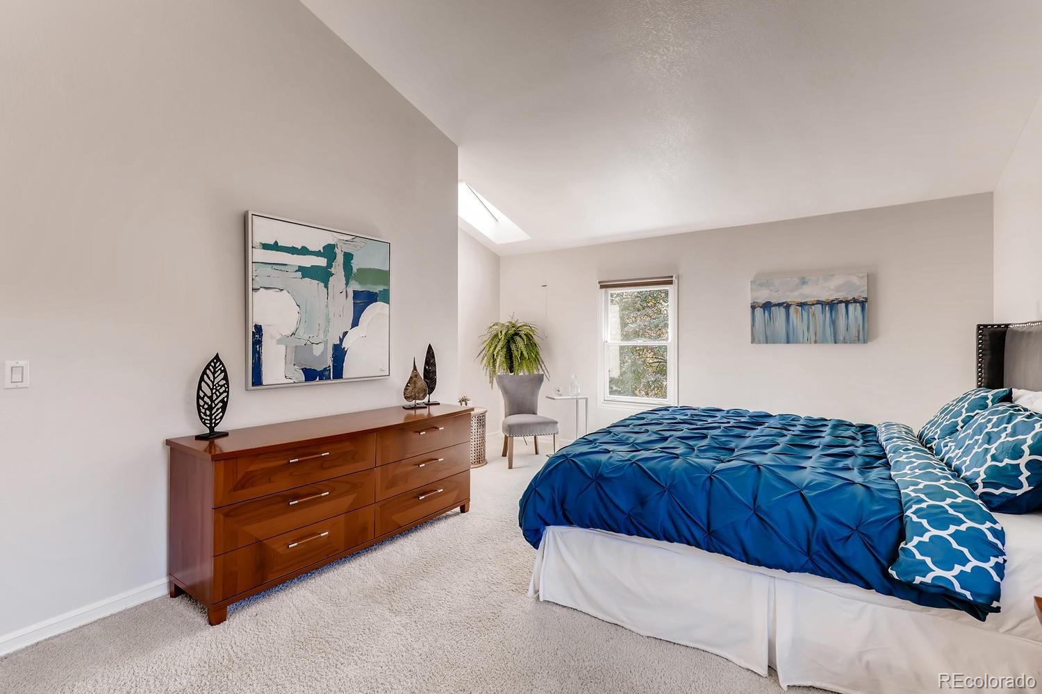 8267 Sweet Water Road Lone Tree, CO 80124 - Photo 12 of 24 a bedroom with a bed and a dresser in it