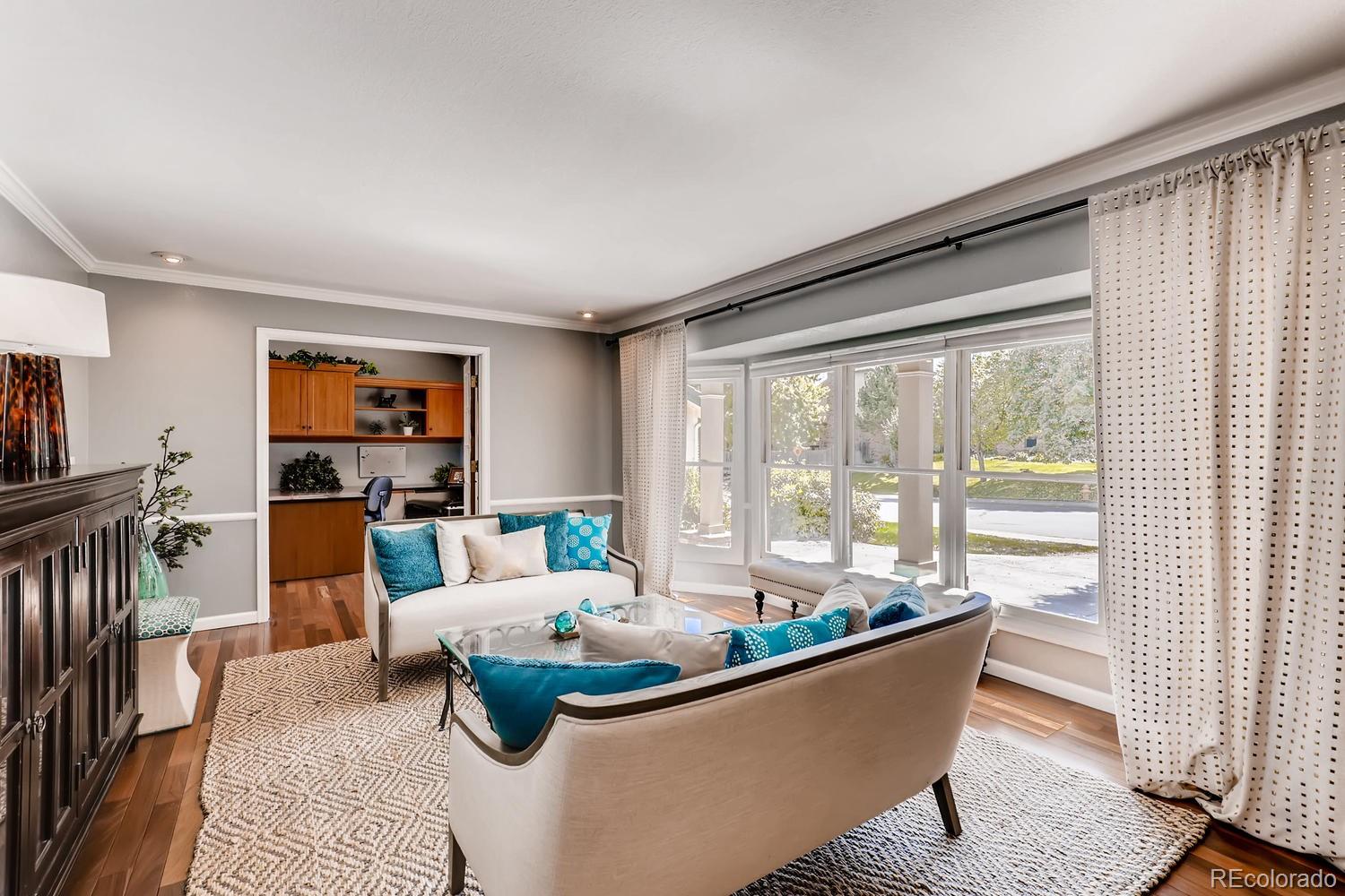 8267 Sweet Water Road Lone Tree, CO 80124 - Photo 6 of 24 a living room with furniture and a large window