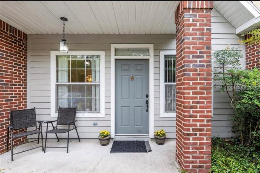 a front view of a house with outdoor seating